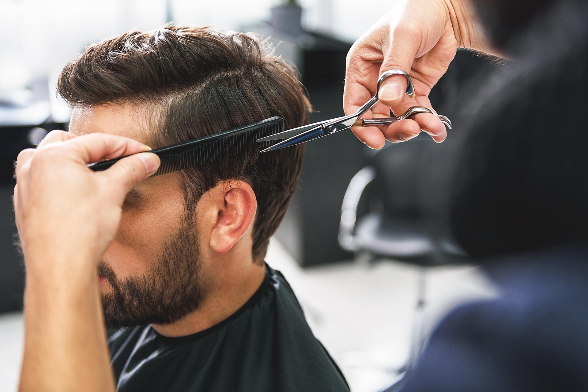 Barber using scissors and comb