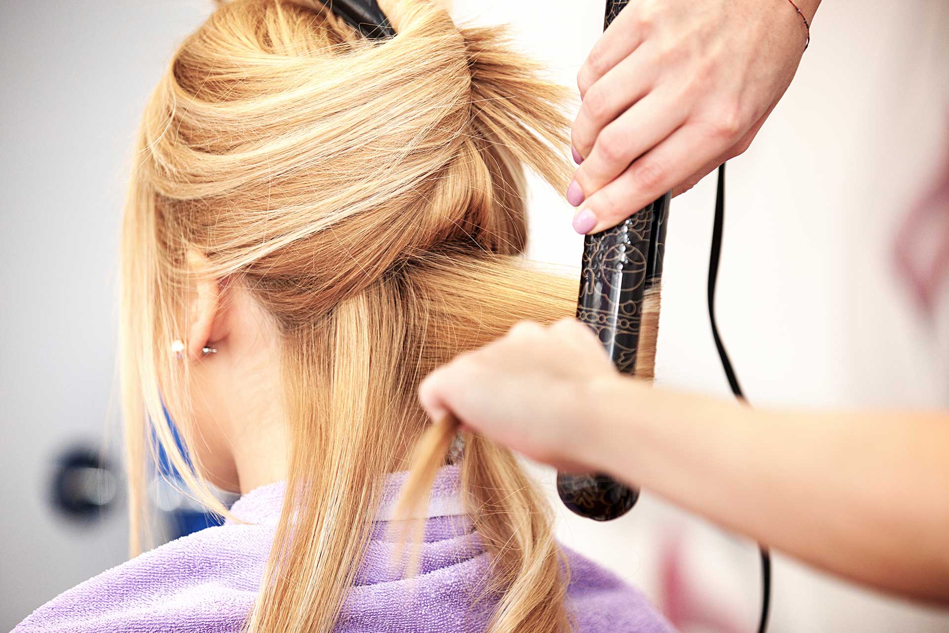 Young beautiful blonde woman enjoying hair treatment.